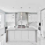 White cabinetry kitchen countertops and oven with window