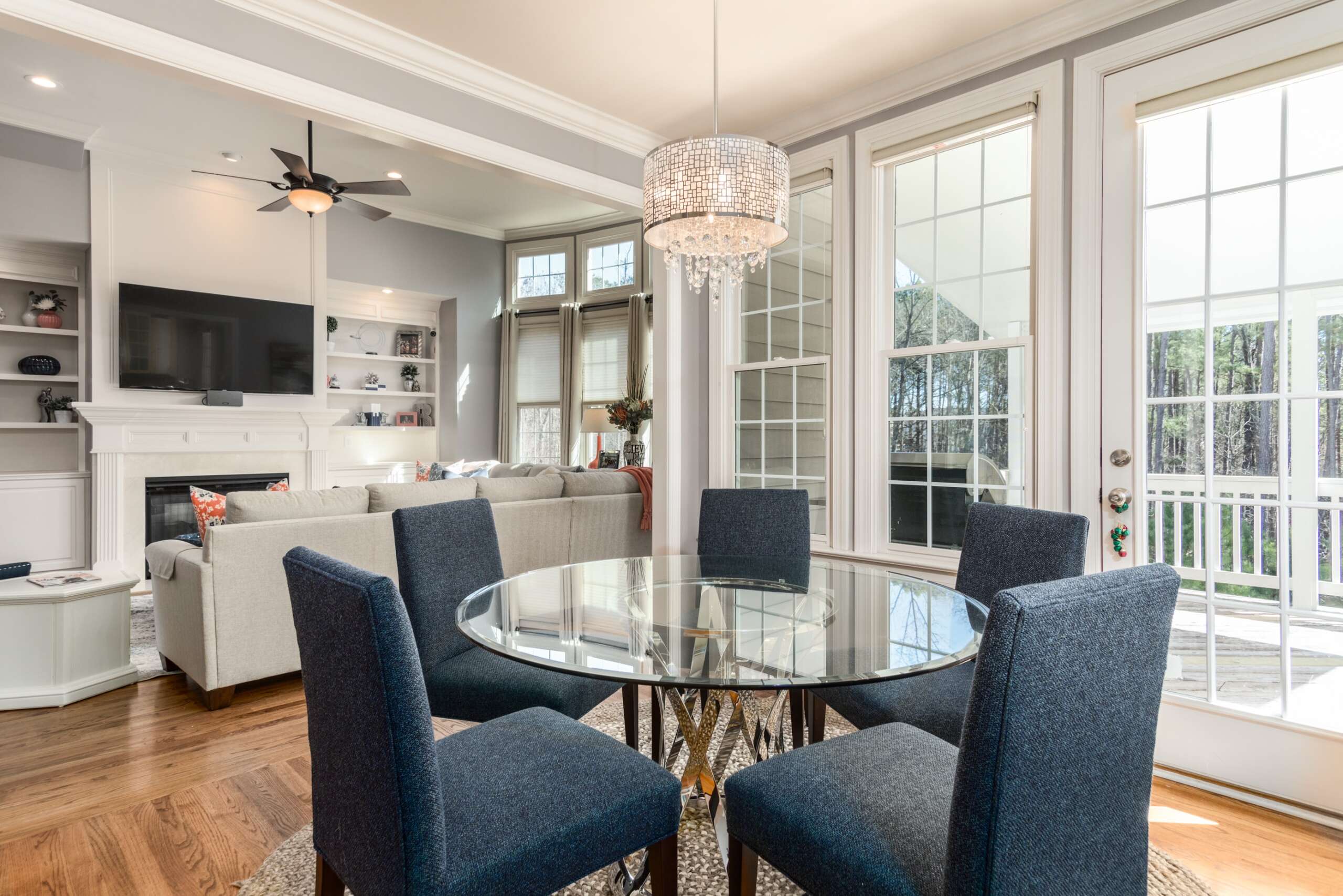 Round glass table with 5 chairs on the living room