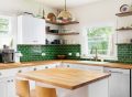 A beautifully designed kitchen featuring a green tile backsplash.