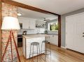 A small kitchen with a stylish kitchen island featuring built-in storage and seating.