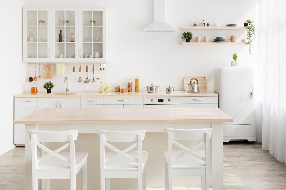 A small kitchen with a stylish kitchen island featuring built-in storage and seating.
