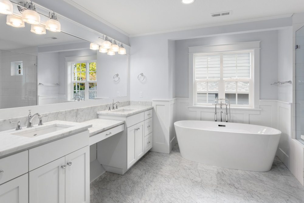 A beautifully remodeled bathroom featuring modern fixtures and a custom vanity.