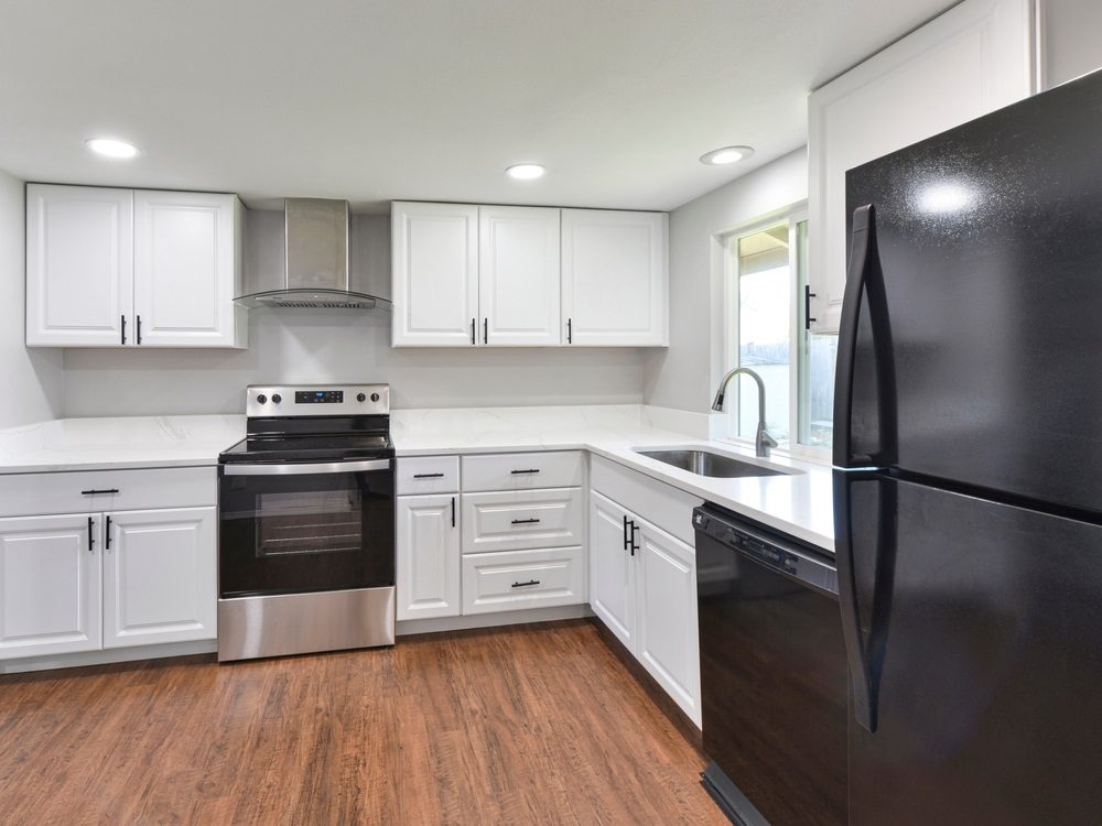 A modern kitchen with updated cabinets, countertops, and stainless-steel appliances.