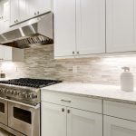 A professionally remodeled kitchen with custom cabinets, countertops, and modern appliances.