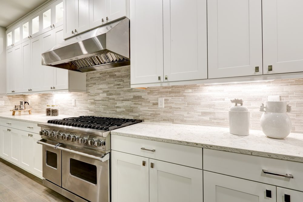 A professionally remodeled kitchen with custom cabinets, countertops, and modern appliances.