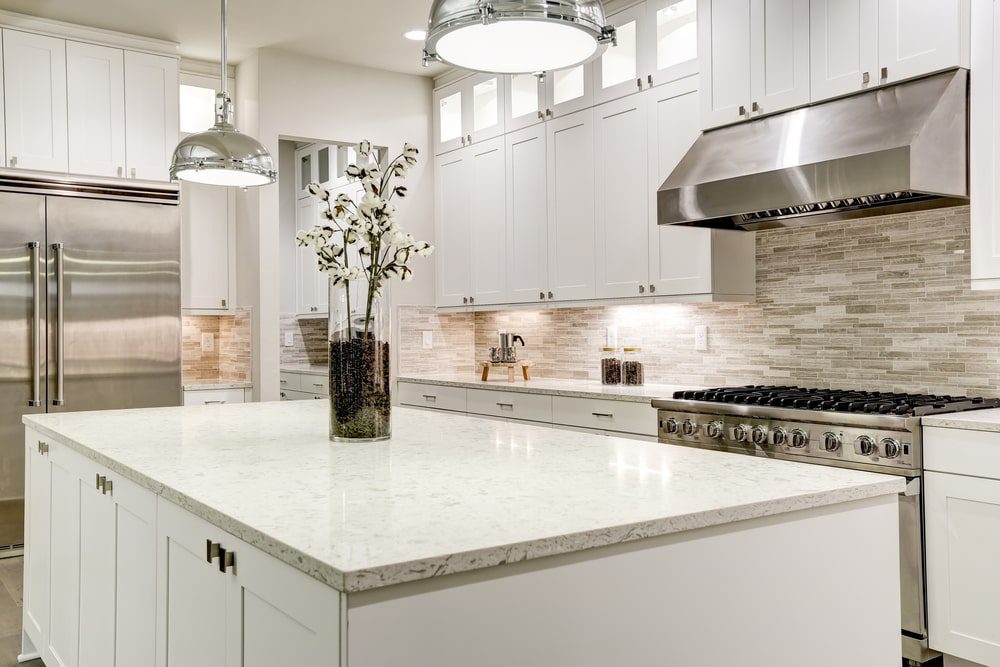 A professionally remodeled kitchen with custom cabinets, countertops, and modern appliances.