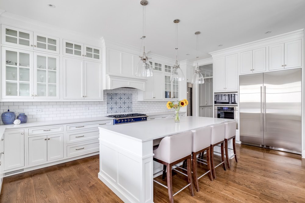 A modern kitchen with updated cabinets, countertops, and stainless-steel appliances.