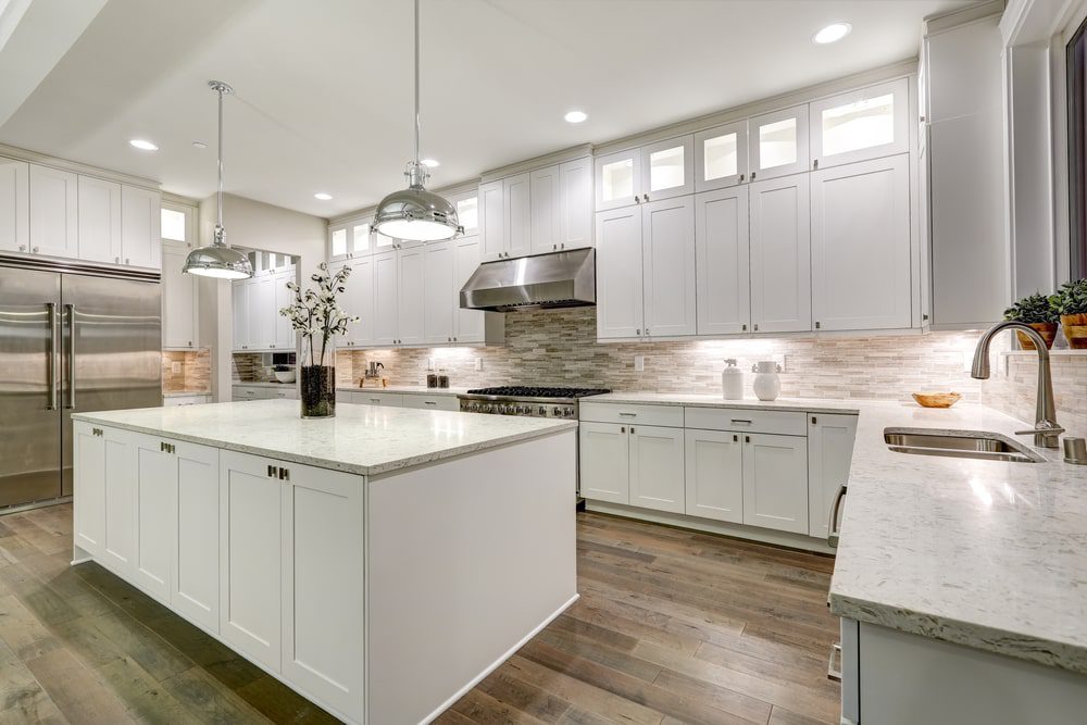 A professionally remodeled kitchen with custom cabinets, countertops, and modern appliances.
