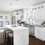 A modern kitchen with updated cabinets, countertops, and stainless-steel appliances.