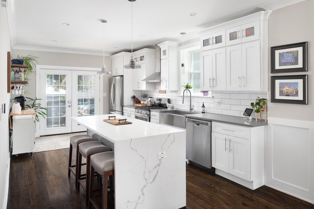 A modern kitchen with updated cabinets, countertops, and stainless-steel appliances.