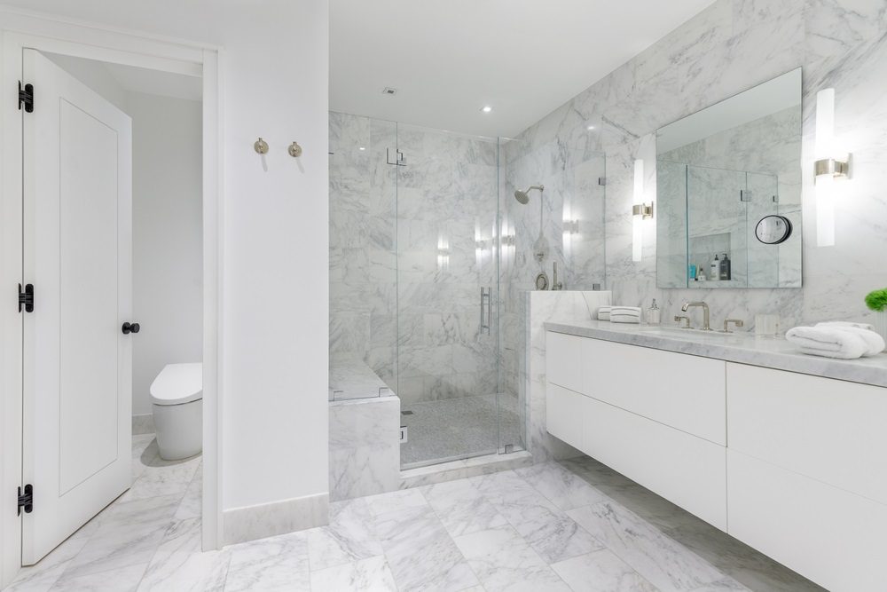 A beautifully remodeled bathroom featuring modern fixtures and a custom vanity.