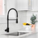 A modern kitchen featuring a contemporary backsplash with geometric tiles.