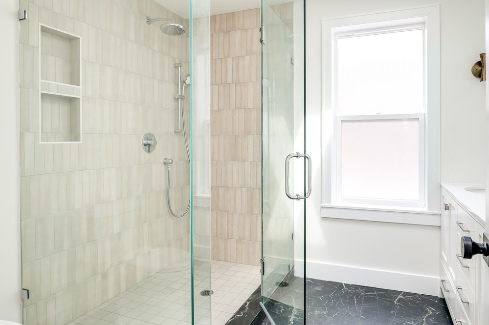 Small bathroom with walk-in shower and glass panels