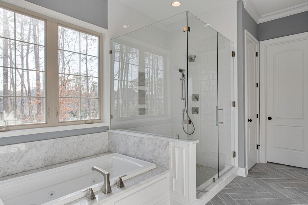 Small bathroom with walk-in shower and glass panels
