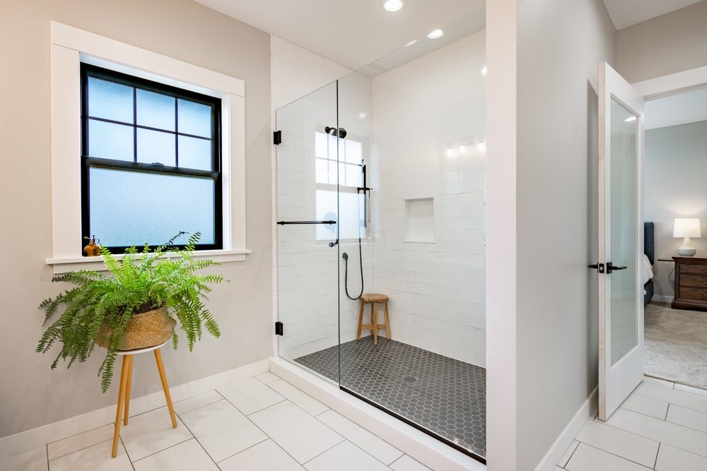 Small bathroom with walk-in shower and glass panels