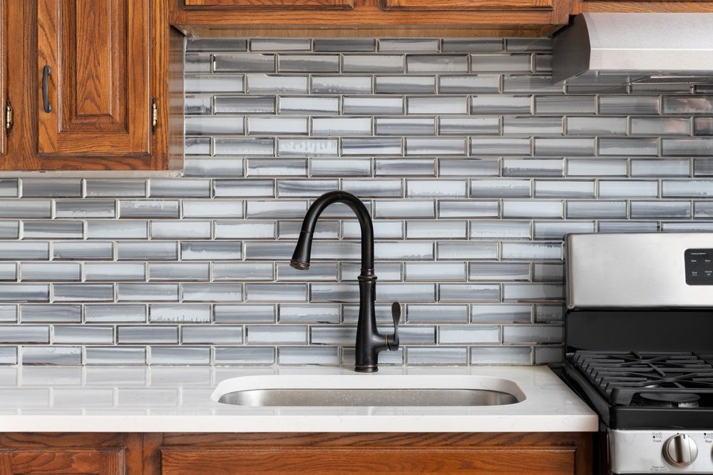 Modern backsplash in a small kitchen with subway tiles and a simple design