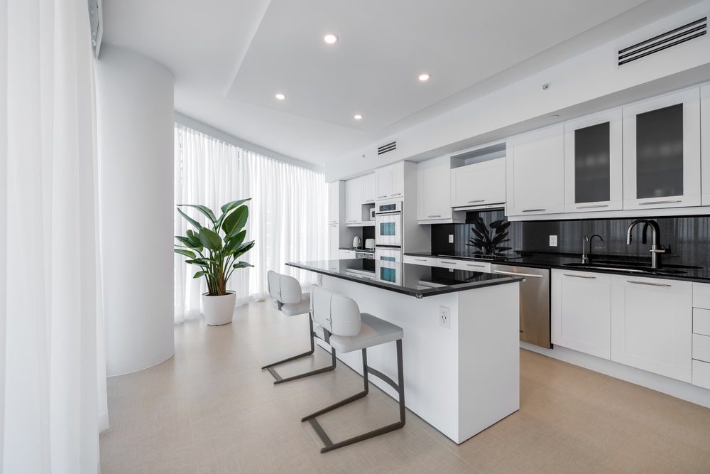 A budget-friendly kitchen remodel showing new paint, countertops, and updated fixtures in a cozy, modern kitchen