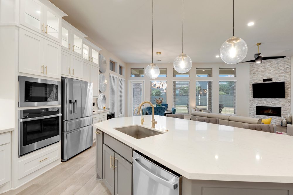 Modern kitchen remodel showcasing white cabinets and stainless-steel appliances, reflecting high ROI.