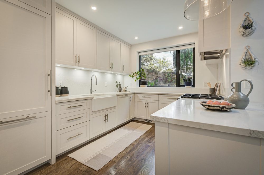 Modern kitchen remodel showcasing white cabinets and stainless-steel appliances, reflecting high ROI.