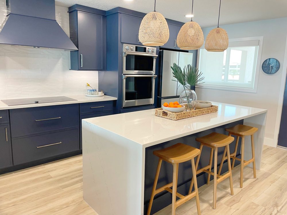 Modern kitchen remodel showcasing white cabinets and stainless-steel appliances, reflecting high ROI.