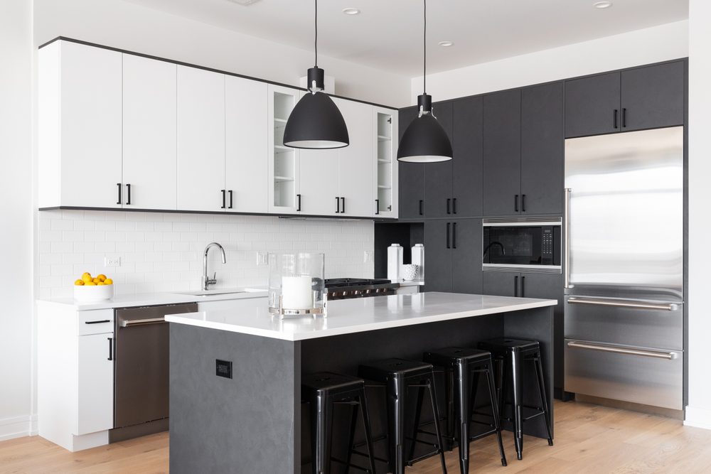 Modern kitchen remodel showcasing white cabinets and stainless-steel appliances, reflecting high ROI.