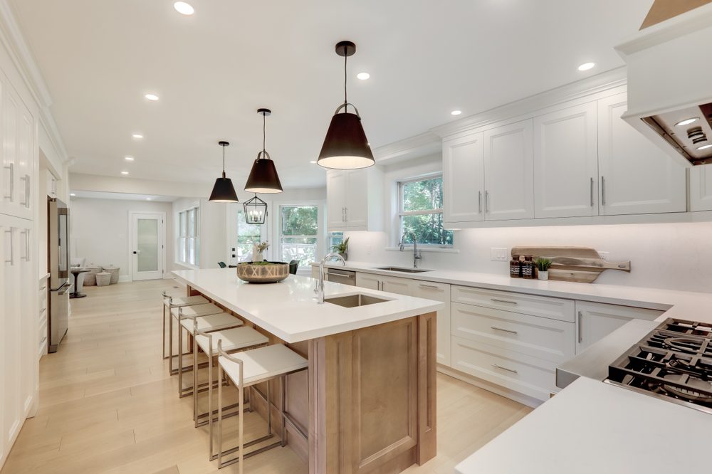 Modern kitchen remodel showcasing white cabinets and stainless-steel appliances, reflecting high ROI.