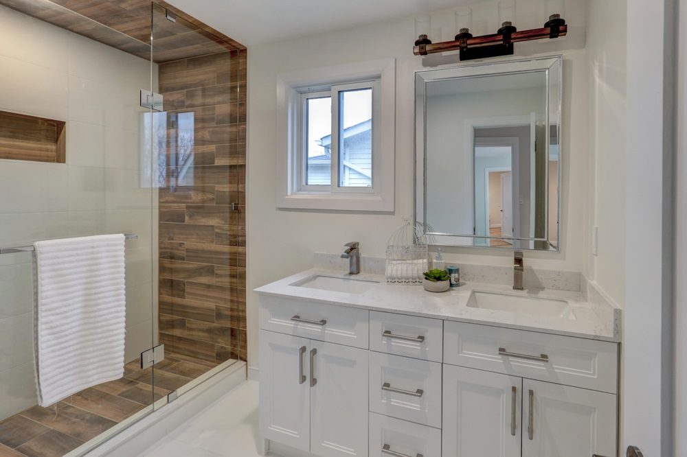 Modern master bathroom layout with freestanding tub, double vanity, and walk-in shower in 2025 design style.