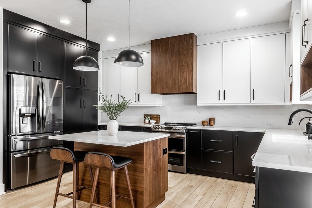 Modern kitchen under renovation, with cabinets removed and new appliances ready for installation.
