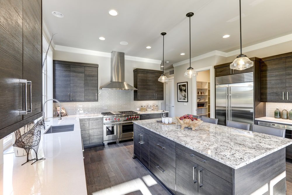  A budget-friendly kitchen remodel showing new paint, countertops, and updated fixtures in a cozy, modern kitchen.
