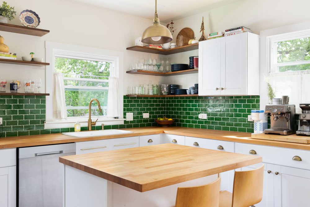 A budget-friendly kitchen remodel showing new paint, countertops, and updated fixtures in a cozy, modern kitchen