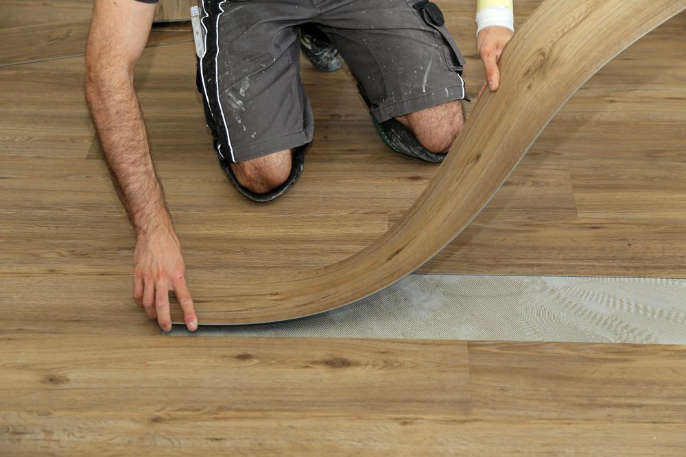 Installing vinyl plank flooring in a modern kitchen