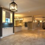 Tile installation with leveling clips, membrane, and trims laid out for a detailed flooring scope