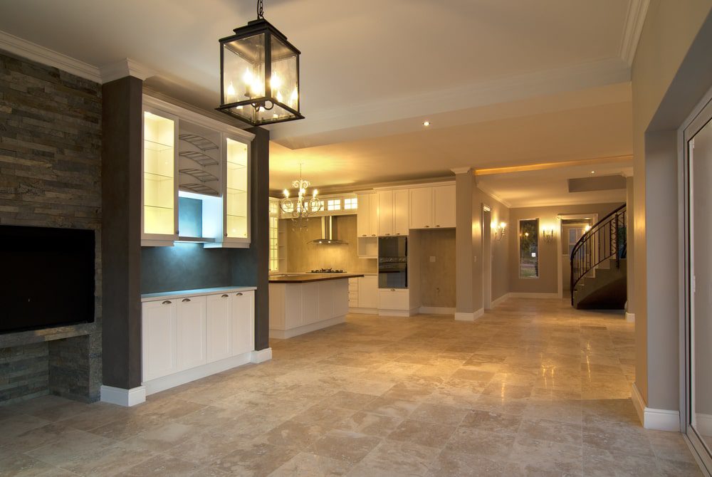 Tile installation with leveling clips, membrane, and trims laid out for a detailed flooring scope