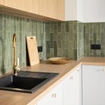 Close-up of wall tile being set with spacers and notched thinset for a clean, level installation