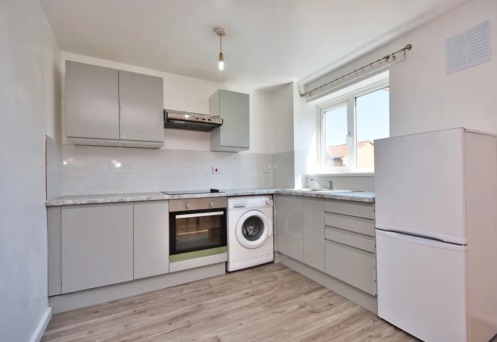 DIY bathroom with vinyl tile flooring being installed, tiles aligned along a chalk reference line 