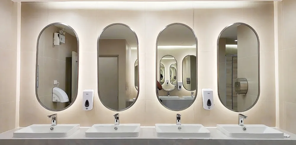 Person tightening a bathroom sink faucet during installation