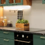 Laminate kitchen countertop being refinished with countertop paint, roller, primer, and protective top coat
