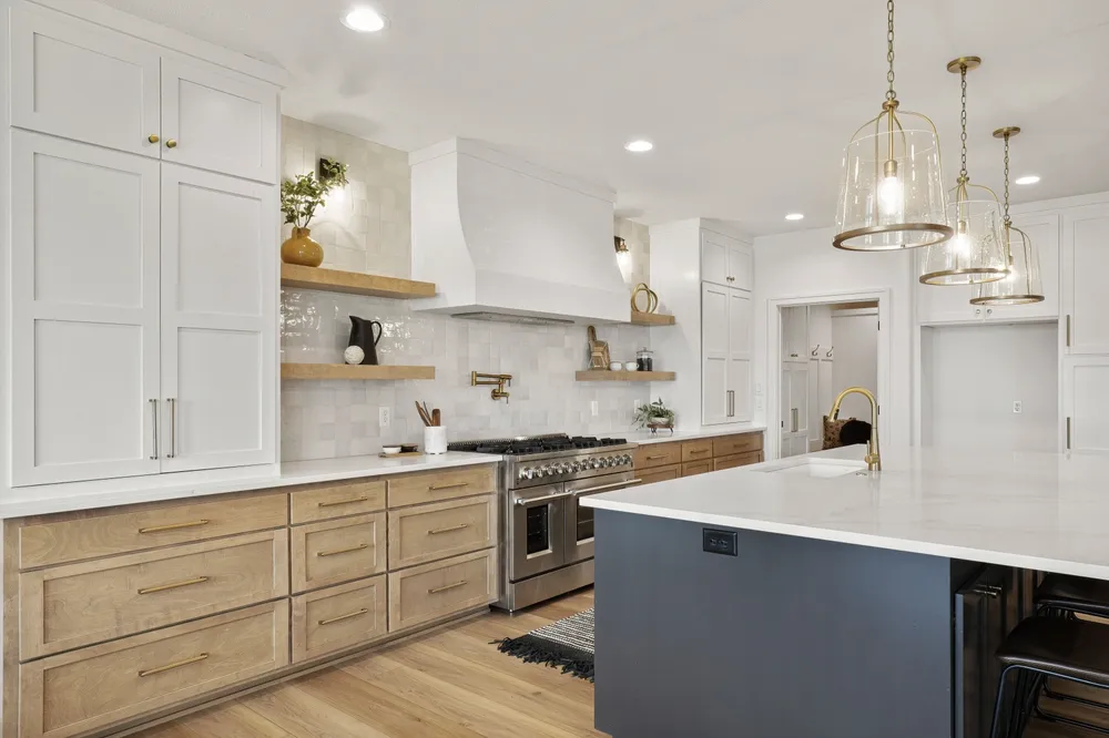 Homeowner measuring kitchen cabinets with a tape measure while recording cabinet dimensions on a floor plan
