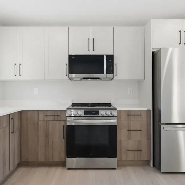 Kitchen with coordinated cabinets, tile flooring, quartz countertops, and warm modern lighting